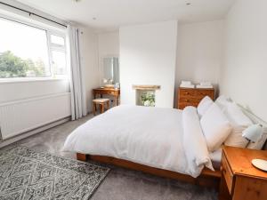 a white bedroom with a bed and a window at Riverview Apartment in Chester