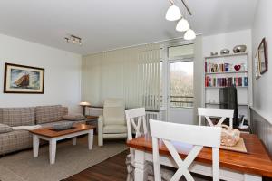 a living room with a couch and a table at Haus Oland Whg 15 in Wyk auf Föhr