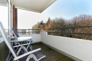einen Balkon mit 2 Stühlen und einem Fenster in der Unterkunft Haus Oland Whg 15 in Wyk auf Föhr