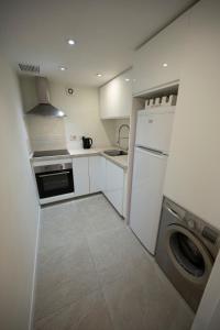 a small kitchen with a washer and a dishwasher at Bright and central 2 bedroom flat in Gibraltar in Gibraltar