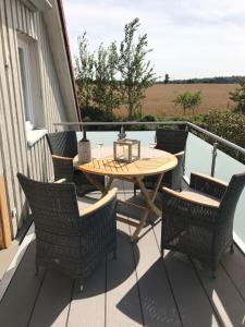 a patio with a table and chairs on a porch at Schleiglück in Rieseby
