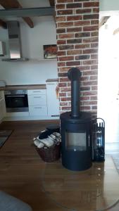 a fireplace in a living room with a brick wall at Bachstelze - 29090 in Neue Tiefe Fehmarn