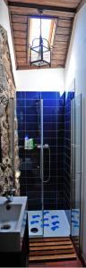 a bathroom with a shower and a sink at Casinha da Horta in Soajo
