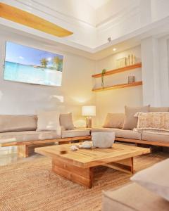 a living room with a couch and a coffee table at Tropical Penthouse in the Heart of Las Terrenas! in Las Terrenas