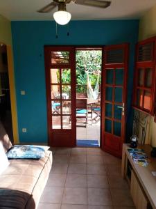 a room with a bed and a sliding glass door at Bungalow charmant à Pointe-Noire avec piscine partagée in Pointe-Noire