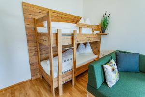a bunk bed in a living room with a couch at Happy Aich 4 by Alpenidyll Apartments in Aich