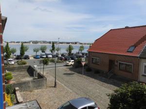 a view of a parking lot and a body of water at Haus Wagner App 3 in Heiligenhafen