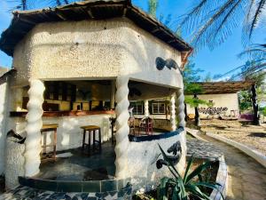 a small house with a table and chairs at Jungle Beach Resort in Sanyang