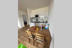 a kitchen with a wooden table and chairs in a room at APARTAMENTO EL SEIFIO in Caleta de Sebo