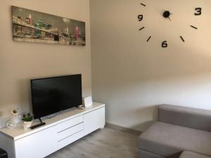 a living room with a television and a clock on the wall at sagrada familia gaudi in Barcelona