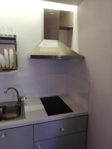 a kitchen with a sink and a stove top oven at Apartment by the Sea,Neoi Epivates Beach, Thessaloniki in Neoi Epivates