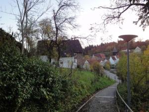a winding road in a village with a street light at OG Stetten 