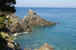a rocky cliff overlooking a body of water at Hotel Bel Tramonto in Marciana