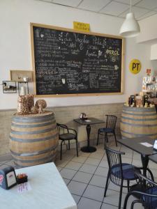 a restaurant with two tables and a chalkboard on the wall at Antico Affittacamere di Tollegno in Tollegno