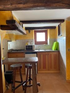 a kitchen with a table and a counter top at Casa vacanze La Carbunera in Domodossola