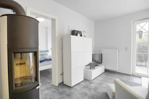 a living room with a fireplace and a tv at Villa Obendtied, FW 2 in Zingst