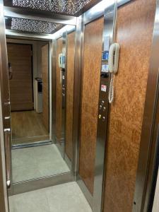 a elevator with a phone and a door with a hallway at Villa Greta in Laives