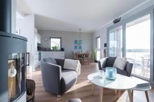 a living room with two chairs and a table at Ostsee - Appartement Nr 152 "11 Ost" im Strand Resort in Heiligenhafen