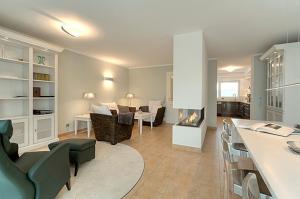 a living room with a kitchen and a living room with a fireplace at MeerZeit - 21843 in Zingst