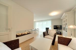 a living room with a couch and a fireplace at MeerZeit - 21843 in Zingst