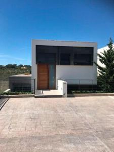 a large house with a white refrigerator in front of it at Luxus Chalet Casas blancas in Cala Mendia