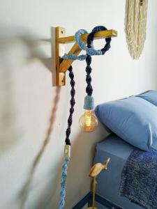 niebieska lina przywiązana do lampy obok łóżka w obiekcie Loft Studio - MAR AZUL w mieście Lauro de Freitas