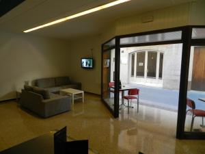 a living room with a couch and a table at Hostal San Carlos in Lloret de Mar