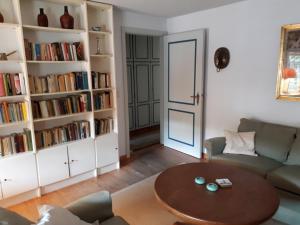 a living room with a table and book shelves at Waldow - Ulmenhof 5 in Nieblum