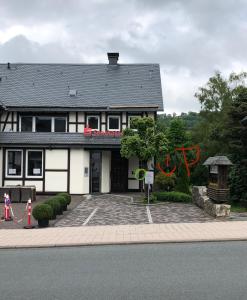 a house with a building with graffiti on it at Monteurzimmer Zimmer + WC in Willingen