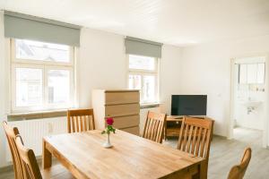 a dining room with a wooden table and chairs at Ferienwohnung Neu "Zum Westerwald" LAHN02 in Löhnberg