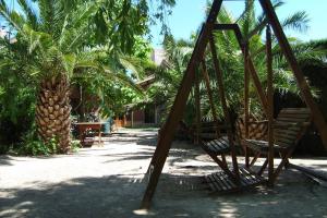 a swing set in a yard with palm trees at Casa en el campo con encanto in Almansa