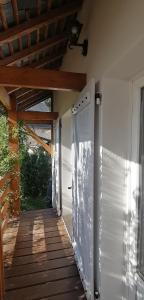 a porch of a house with a wooden deck at Charmante maisonnette in Orléans