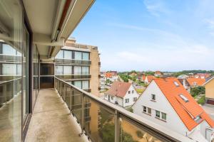 an apartment balcony with a view of a city at Refurbished comfortable app 1min from the sea in Koksijde