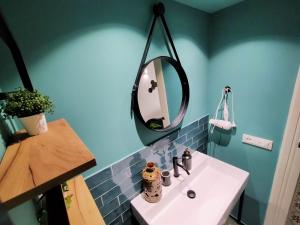 a bathroom with a sink and a mirror on the wall at Sonnino Suite jacuzzi apartment in Bari