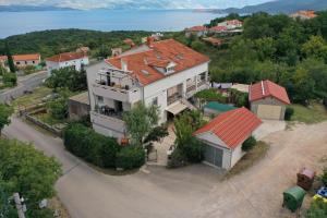 a large white house with a red roof at Apartments House Risika in Risika