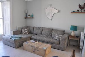 a living room with a couch and a coffee table at Luxury dog friendly home in Brixham harbour with sea views and free parking in Brixham