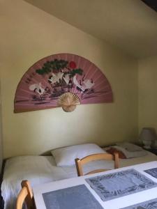 a bedroom with a bed with a painting on the wall at Cascina Garaita in Fossano +48 photos
