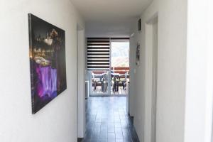 a hallway leading to a dining room with a painting on the wall at Paulinio in Jajce