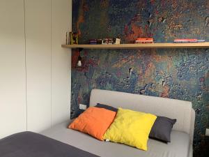 a couch with two colorful pillows on it in a room at Apartment Nadia in Ełk