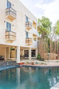 a house with a swimming pool in front of it at Botånica Tulum in Tulum