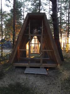 a tiny house in the woods with a window at Wind Hunters Surf Station in Sosnovyy Bor