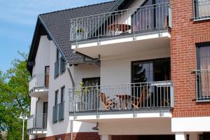 two dogs sitting on the balconies of a building at Seestern FW 2 in Zingst