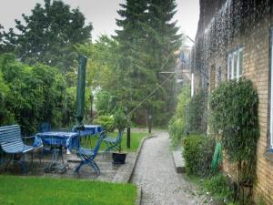 a patio with a table and chairs in a yard at Altes Rektorenhaus 1 in Rieseby