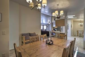 a dining room and living room with a wooden table at Rustic Retreat Moab Townhome with Grill and Fire Pit! in Moab