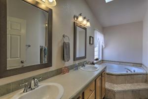 a bathroom with two sinks and a tub and a mirror at Rustic Retreat Moab Townhome with Grill and Fire Pit in Moab +26 photos