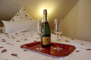 a bottle of wine on a tray with two wine glasses at "Rosenkate 2" in Riepsdorf