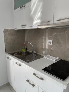 a kitchen with a sink and a counter top at Villa Angelina Ksamil in Ksamil +37 photos
