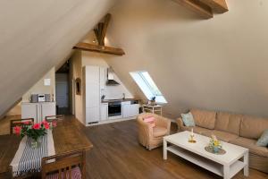 a living room with a couch and a table at Ferienwohnung 8 für 4 Personen Seeblick in Neuenkirchen