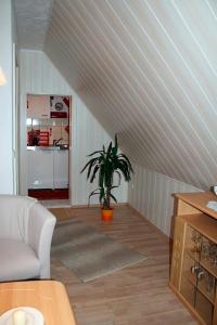 a living room with an attic with a plant in it at Voß, FW in Zingst