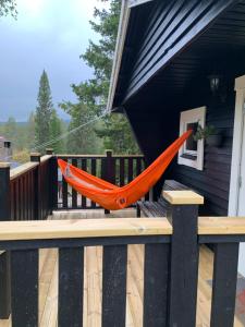 an orange hammock hanging from the side of a porch at Gilleråsvägen 13 C in Sälen